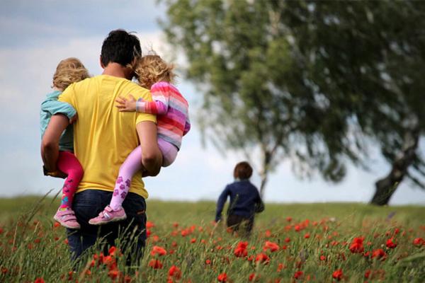 Dad carrying children